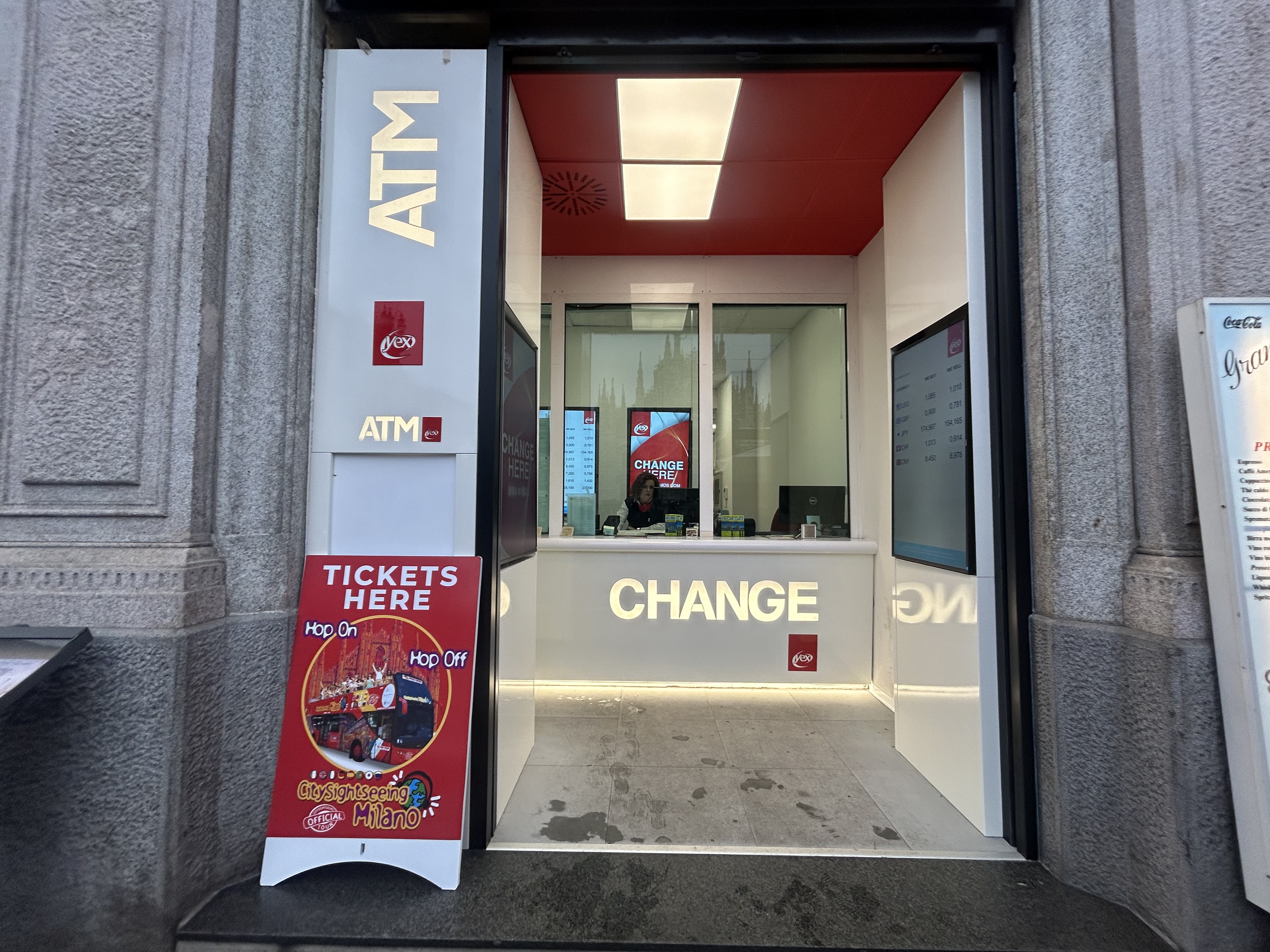 yex Change Agency in Piazza Duomo in Milan, with currency exchange counter and ATM service