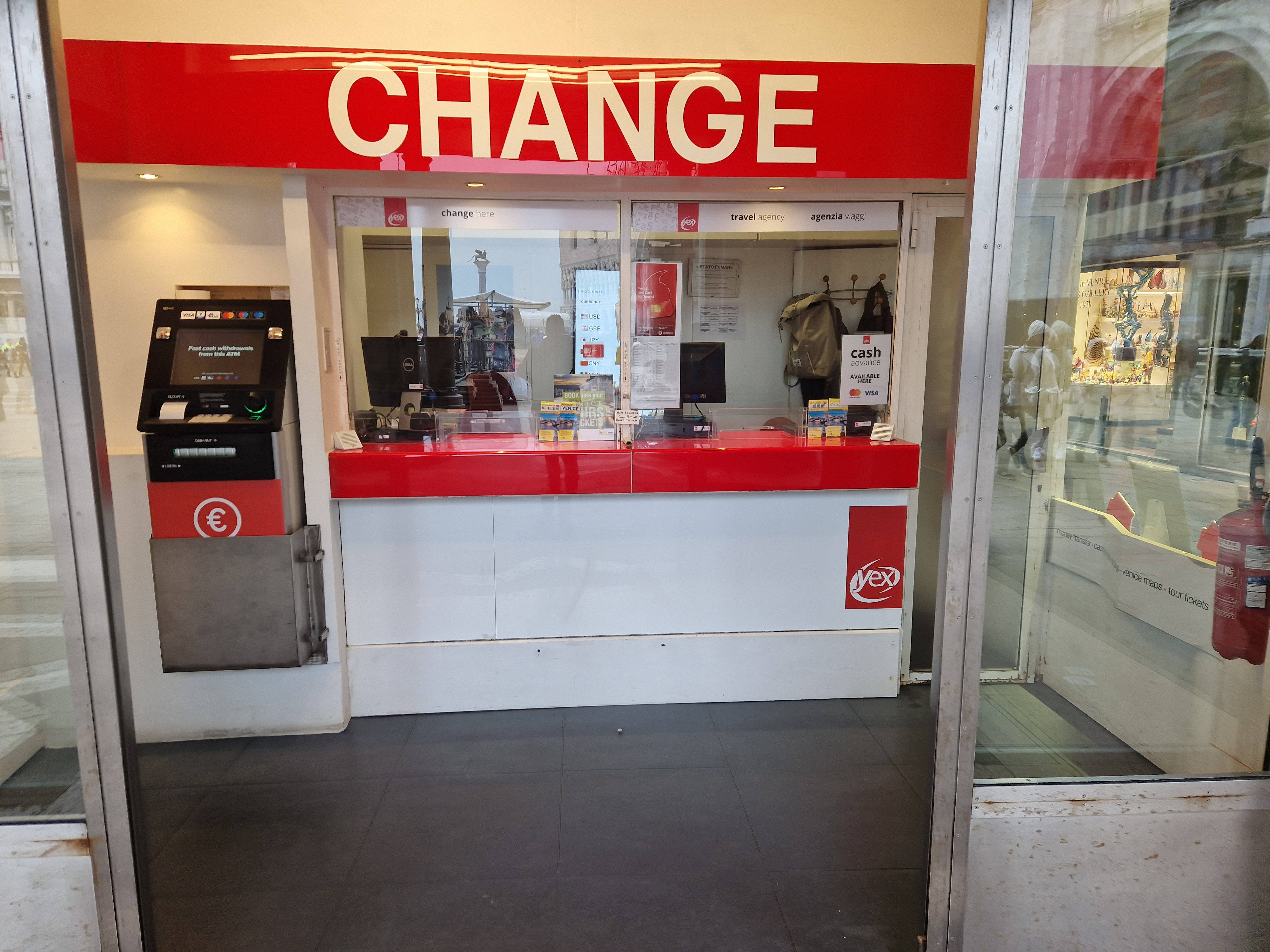 Close-up photo of the Yex Change currency exchange counter under the arcades of Piazza San Marco in Venice