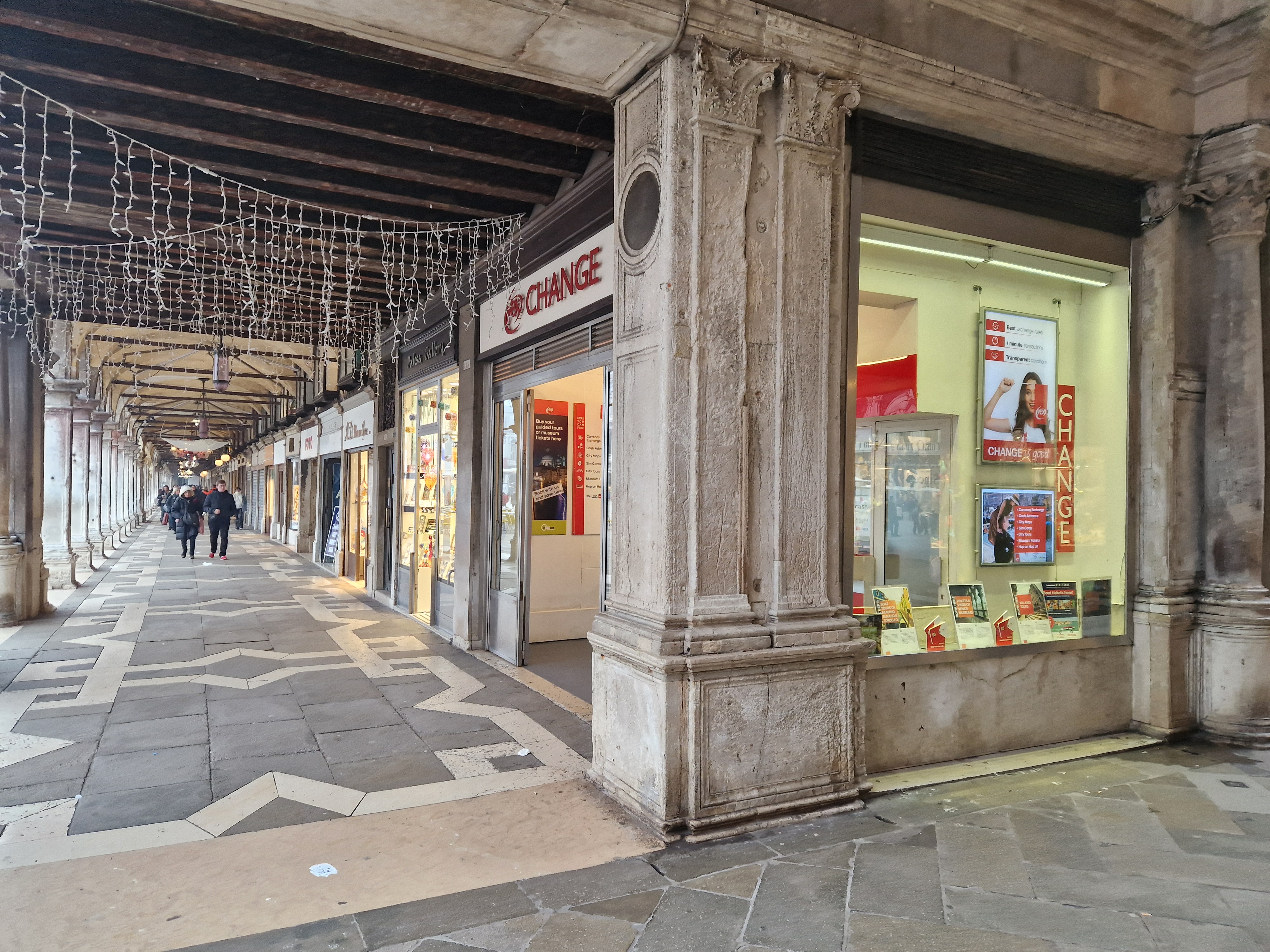 Panoramic view of the front office of the Yex Change agency under the arcades of Piazza San Marco in Venice