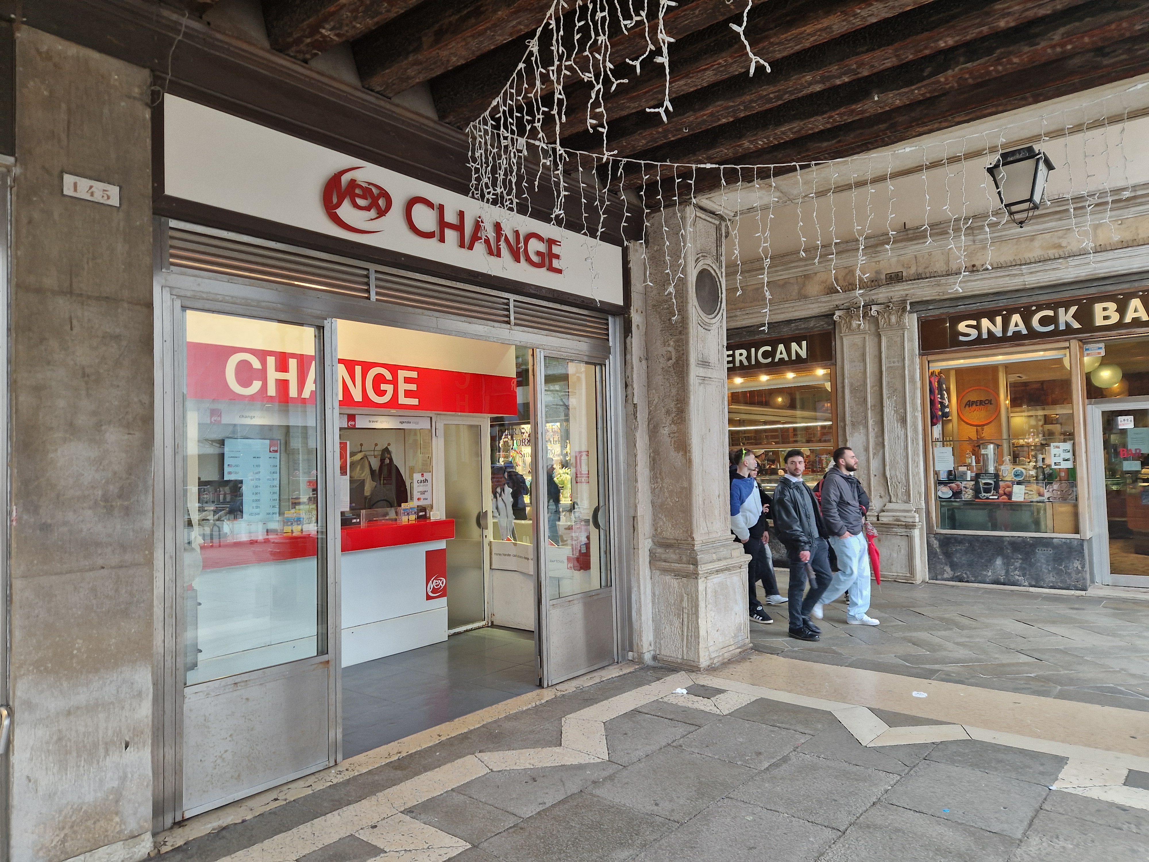 Second panoramic view of the front office of the Yex Change agency under the arcades of Piazza San Marco in Venice