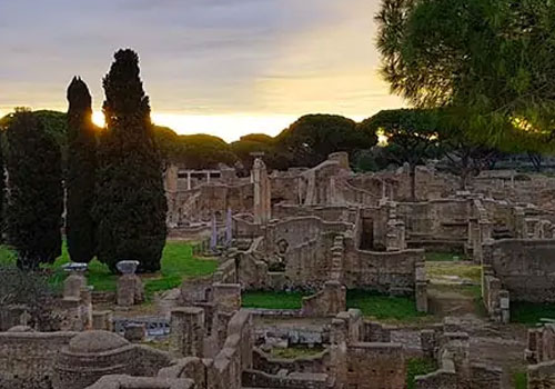 Ruins of the Ostia Antica Archaeological Park with ancient brick structures, columns and Mediterranean vegetation