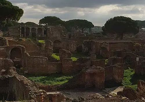 Ruins of the Ostia Antica Archaeological Park with ancient brick structures, columns and Mediterranean vegetation